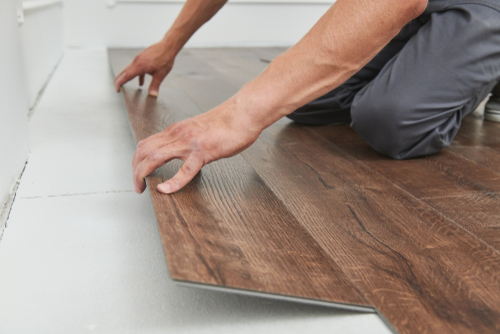 Worker,Joining,Vinyl,Floor,Covering,At,Home,Renovation
